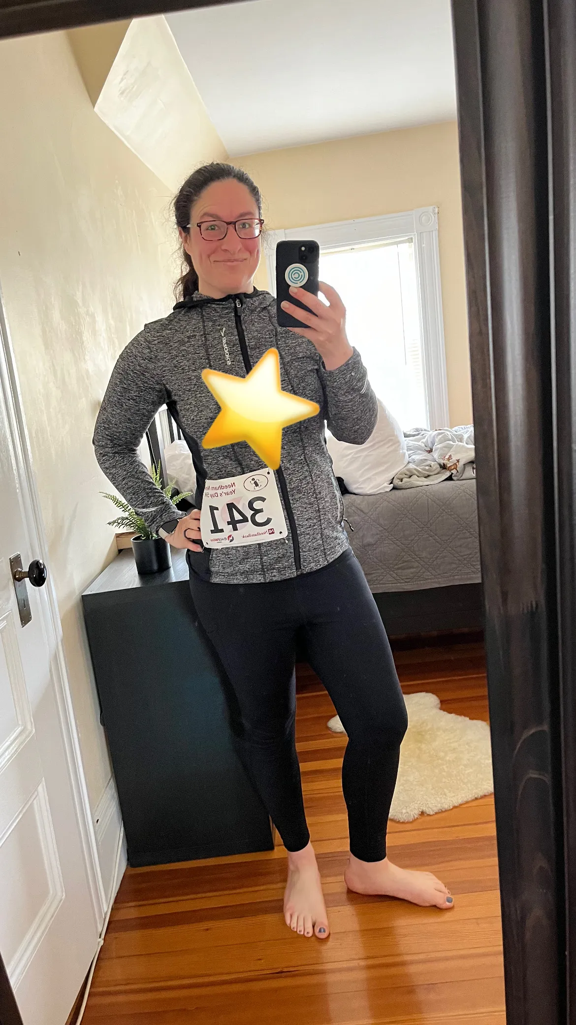 Photo of Sam Tackeff in front of a mirror wearing running gear and a race bib